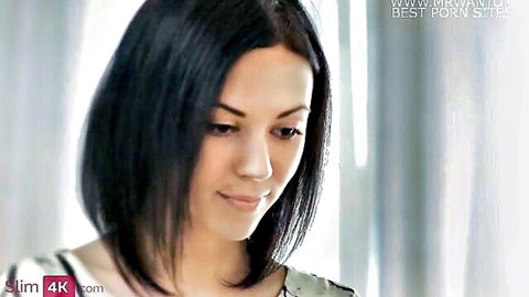 Sheri Vi looking thoughtful in white top, black bob hair beauty