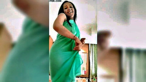 Yasmine in sexy green saree, smiling and posing seductively
