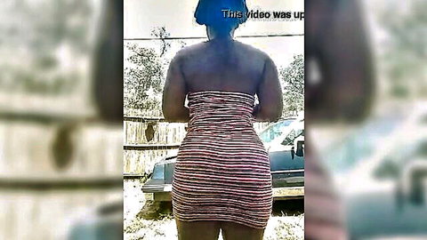 Thick ebony babe in tight striped dress shows off her huge round ass from behind outdoors