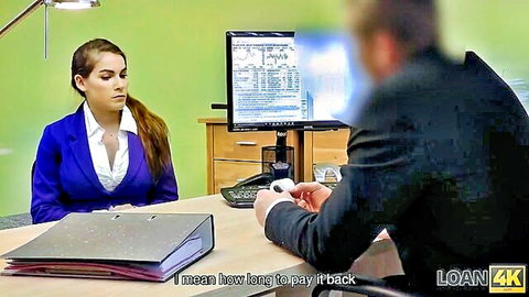 Brunette babe in blue blazer at office desk negotiating loan repayment with suited man