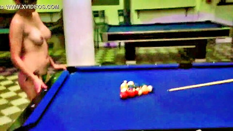 Topless Latina teases with pool cue in public mischief