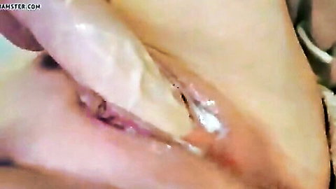 Close-up of creamy creampie pussy spread wide by fingers with thick cum oozing out