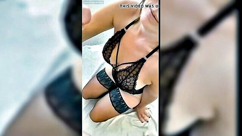 Sexy MILF in sheer black lace lingerie bra and garters teasing big tits on bed