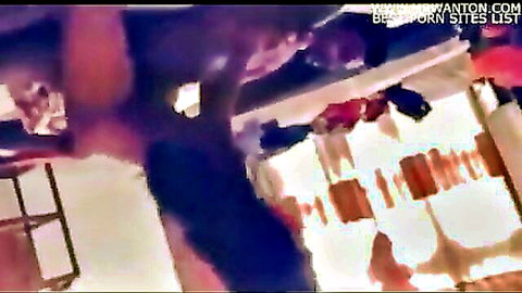 South Asian man exposes thick erect cock in dimly lit laundry room with hanging clothes