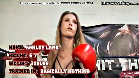 Blonde Ashley Lane in skimpy black lingerie and red boxing gloves posing fiercely