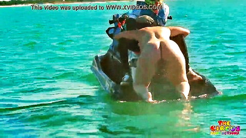 Nude woman bent over on jetski in ocean, outdoor water fun
