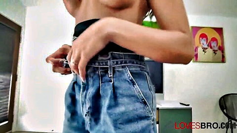 Topless tanned babe unbuttons baggy jeans teasing her bare tits and hips