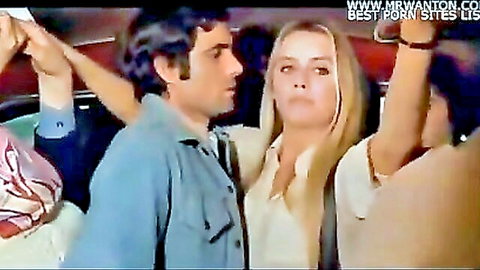 Busty blonde seducing man in crowded bus vintage scene