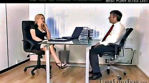 Blonde femdom boss in short black dress seduces suited man across office desk
