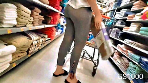 MILF with huge ass in tight gray yoga pants bending over in store aisle
