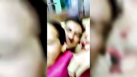 Blurry closeup of smiling South Asian women with big tits in pink top teasing