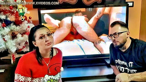 Shocked Asian MILF and bearded guy watch hardcore anal pounding on TV during Christmas