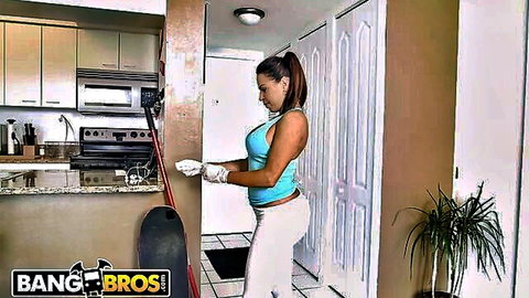 Busty Latina maid Julianna Vega in tight blue top and white pants, cleaning with gloves