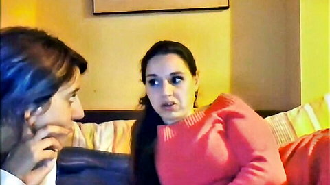 Petite brunette in pink sweater chats intimately with handsome guy on bed