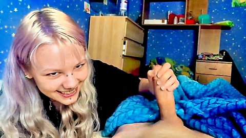 Pierced blonde teen smiles while gripping and stroking big hard cock handjob