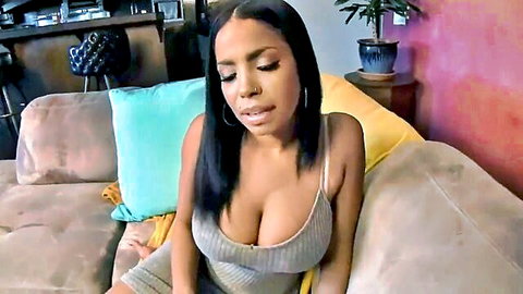 Havana Ginger in tight gray dress showing deep cleavage, seductive gaze