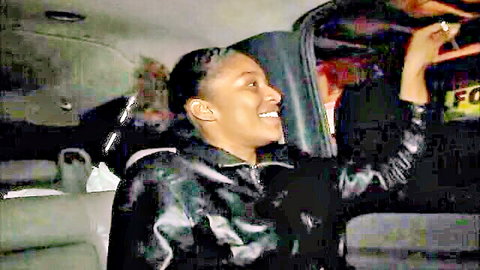 Smiling ebony woman in leather jacket inside car, amateur car sex scene