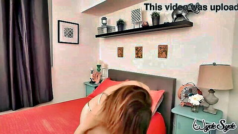 Sara Jay nude on bed, teasing with huge dildo solo play