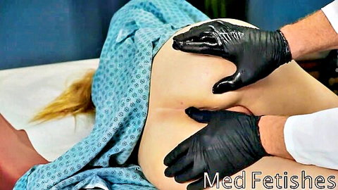Gloved doctor spreads blonde patient's bare ass cheeks exposing holes in medical exam