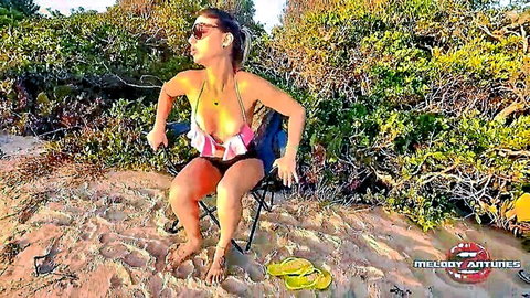 Tanned curvy babe in pink frilly bikini poses spreading legs on beach chair