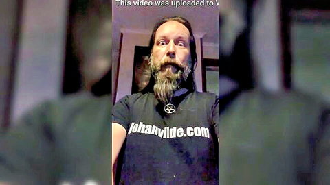 Bearded long-haired man in black t-shirt for verification video