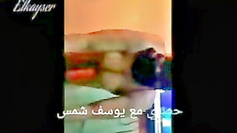 Syrian lesbian lovers in intimate embrace on bed, passionate Arab couple