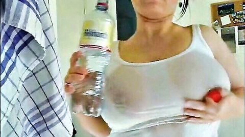 Busty amateur in see-through wet white t-shirt, teasing with water bottle