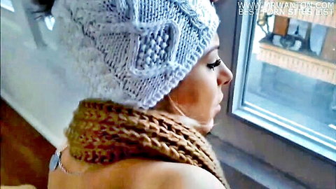 Topless blonde in white knit beanie and brown scarf, side profile tease