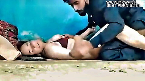 Bearded Indian man fucks busty desi woman in red bikini missionary on sand with tits out