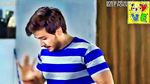 Handsome Indian man in blue striped t-shirt gesturing seductively with hand palm up
