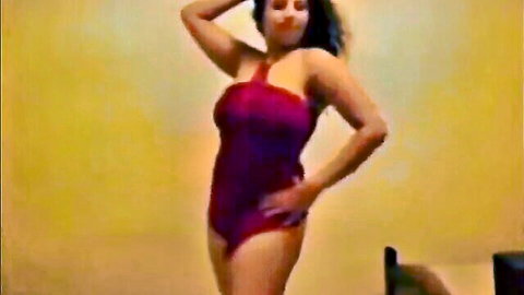 Seductive Arab woman in tight red swimsuit posing curvy