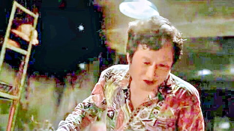 Mature man in floral shirt with intense expression in adult scene