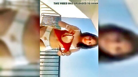 Gema stripping topless on balcony, exposing perky tits in outdoor tease