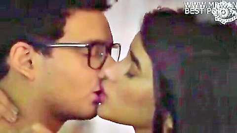 Passionate Indian couple kissing in red top and glasses, desi romance scene