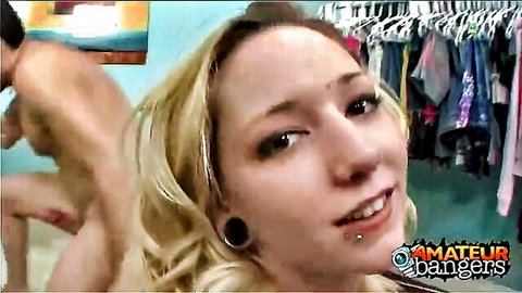 Smiling blonde pierced teen babe with big natural tits poses nude as boyfriend hugs from behind