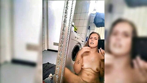 Slutty blonde mommy nude selfie in bathroom, showing toned body and tattoos