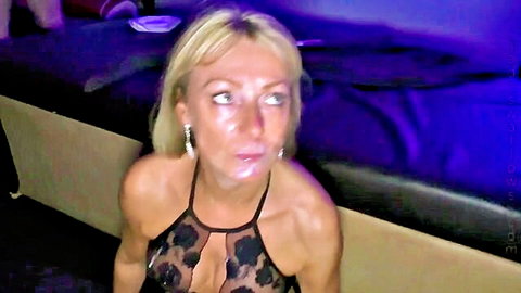 Blonde in revealing lace top, seductive sideways glance