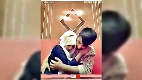 Bangladeshi hijabi girlfriend intimately hugged by boyfriend on store couch