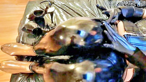 Shiny black latex legs in high heels and gloves, feet fetish tease