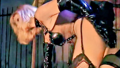 Angel Hart bent over in latex harness for gangbang, exposed ass and stockings
