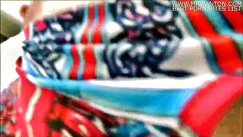 Blurry close-up of woman in colorful patterned scarf, teasing mystery