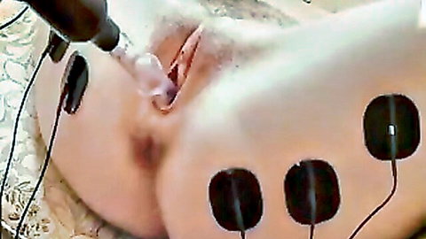 Lesbian BDSM close-up: woman with electro pads on ass, vaginal insertion device from Lesbian X