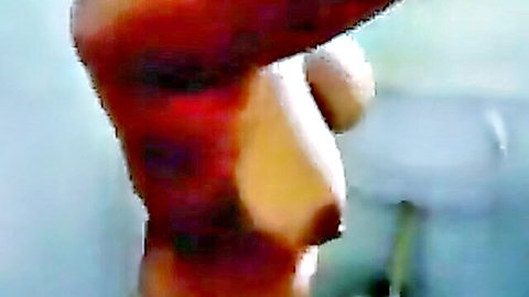 Close-up of South Asian woman's bare tits with erect dark nipples fully exposed.