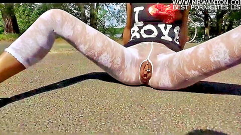 Iris spreads legs in crotchless white lace leggings, exposing pussy outdoors