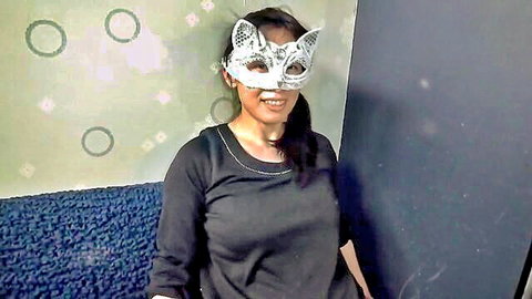 Japanese woman with seductive cat eye mask, smiling in black top