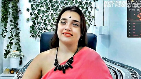 Indian cute girl in pink saree smiling seductively, teasing reveal