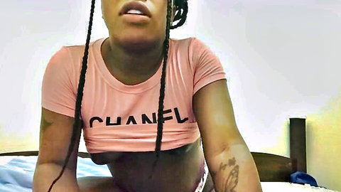 Curvy ebony woman in pink Chanel crop top and panties teases underboob on bed