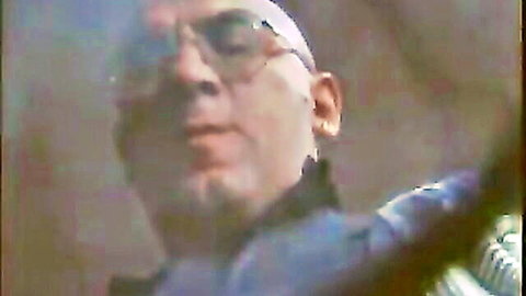 Vintage close-up of bald mature man with glasses and goatee in MILF porn scene
