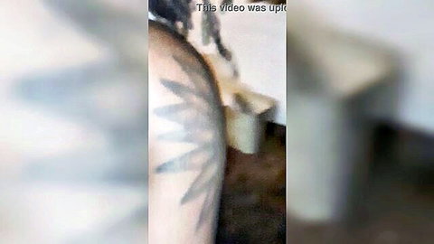 Blurry closeup of nude white woman's round ass with starburst tattoo on hip from behind