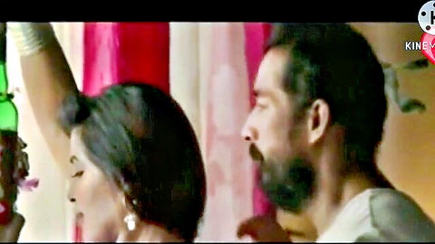 Desi woman in red saree with bearded man in intimate embrace